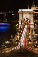 Long-exposure night shot of a square, a bridge and their traffic