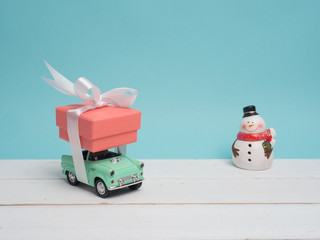 Colorful gift box warp white ribbon and decoration object and cute vintage car on pastel color background for Christmas and The New Year .