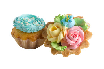 colorful muffins, flowers made of cream on to, isolated on white 
