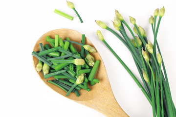 bunch of fresh chives on a wooden cutting board