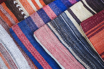 Pile of beautiful handmade carpets on the market in Istanbul Gra