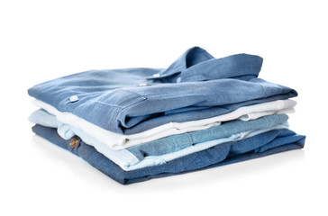 Stack of colorful shirts on white background