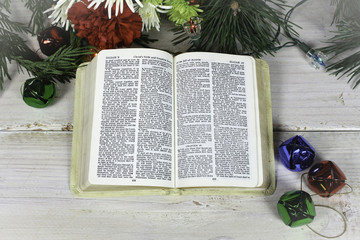 Open bible with bells and flowers Christmas Theme
