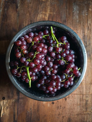 Red wine Grapes in a bowl on wood background