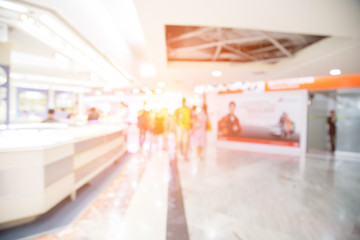 blurred image of shopping mall and people .
