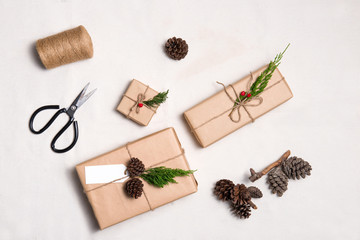Fototapeta na wymiar Christmas presents. Packages wrapped in kraft paper tied with ju