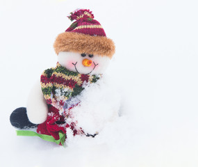 Snowman on the white snow in winter background for Christmas.