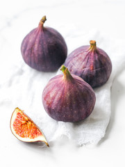 Fresh figs and slice of fig on white background