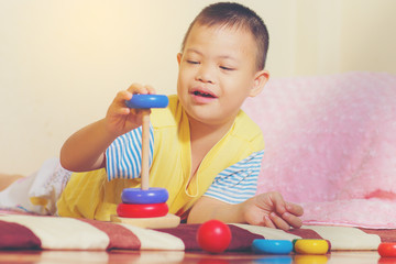 Little boy play color wooden toy at home