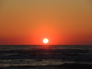 Fiery sunrise at Italian beach. Summer season. Emilia Romagna region. Adriatic sea. Italy