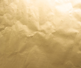 Gold wrinkled paper texture abstract background