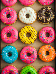Colorful donuts in takeaway box