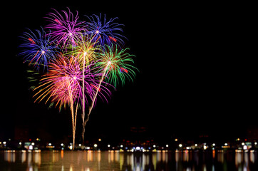 Fireworks celebration and the city night light background.