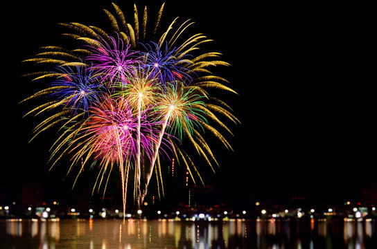 Fireworks celebration and the city night light background.