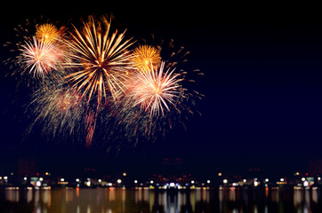 Fototapeta premium Fireworks celebration and the city night light background.