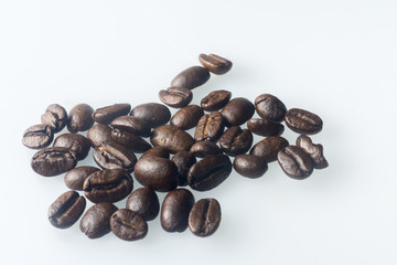 Coffee beans roasted close up white background.