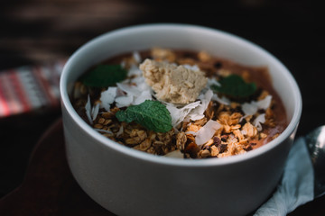 Smoothie bowl on the table with mobile phone and spoon