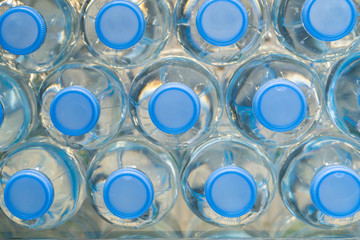 Image of many plastic bottles with water in a shop

