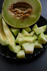 chopped ripe melon slices and served on a black plate