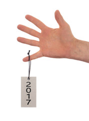 Hand holding a tag - New year - 2017