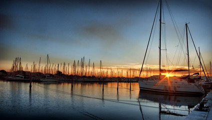Naklejka na ściany i meble Marina at dawn with boat in the foreground
