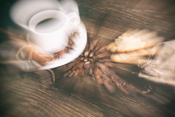 Coffee composition with black coffee, cinnamon and cookies on the old wooden table  