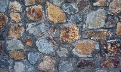Fragment of old stone wall close-up