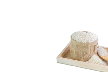 White long rice in a sack and wooden scoop isolated on white background
