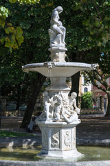 Baroque fountain on the promenade of the river Urumea, Donostia-San Sebastian. The riverside promenade is decorated with sculptures and artwork. The city is European Capital of Culture 2016