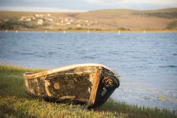 Old boat on river bank