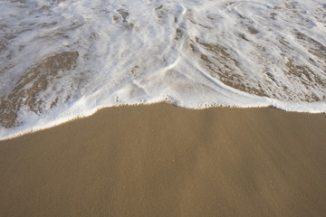 Sea water and foam on beach