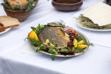 carp  with lemon, dill and raisins on plate