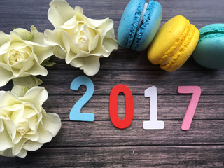 2017. New year 2017. New year wooden date 2017 with flwoers and macaroons