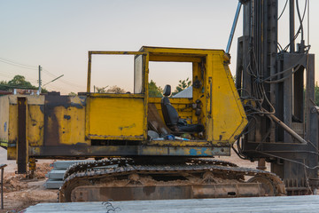 Fototapeta na wymiar old yellow powerful construction machinery , focused beside of machinery.