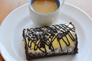 chocolate cake roll filled cream eat couple with coffee on plate