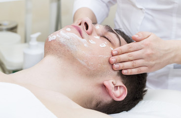 Man in the mask cosmetic procedure in spa salon