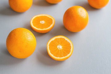 A beautiful yellow color of oranges, orange slices, laying on light blue rustic wooden table, oranges fruit with high vitamin C, vintage style of color tone, horizon shot, overhead shot