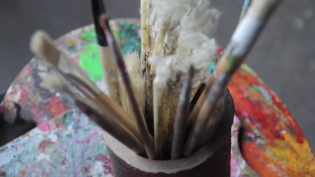 artist's brushes and vintage fan