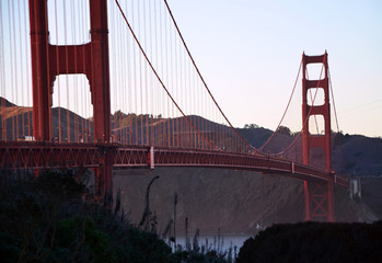 Close up view of Golden Gate bridge at sunset on a cold wet summer day