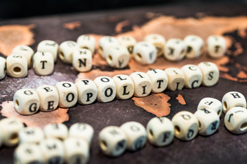 Wooden blocks forming the word geopolitics on table - obrazy, fototapety, plakaty