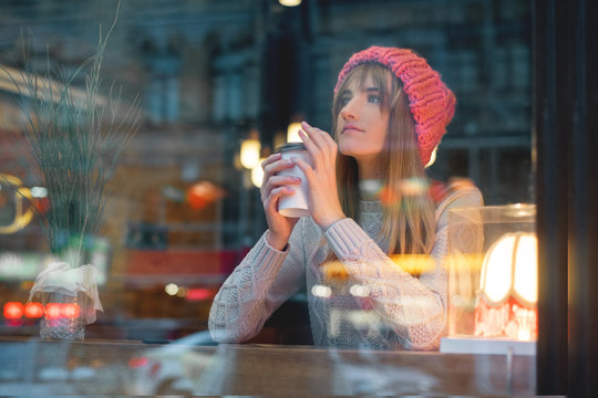 young girl with a coffee on a walk