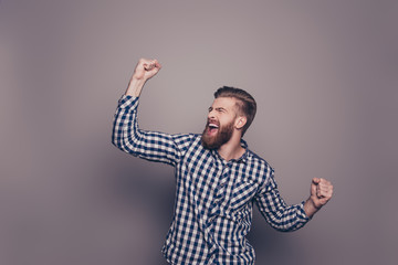 Fototapeta premium Yes, he did it! portrait of stylish happy bearded man raised han
