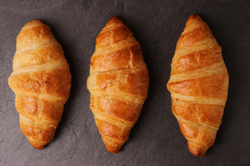 Croissants on stone slate board. Top view.