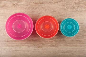 Plastic round lunch boxes on table