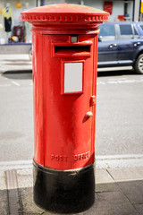 Typical English mailbox on a street in England