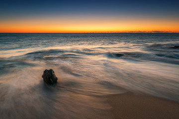 Fototapeta na wymiar Lone piling long exposure seascape sunrise 