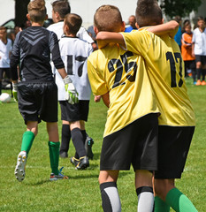 Young soccer players are happy after winning the match