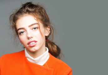 pretty fashionable girl in orange jacket