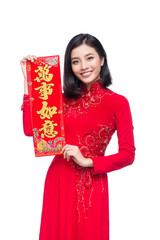 Fototapeta premium Portrait of a beautiful Asian woman on traditional festival Ao Dai.