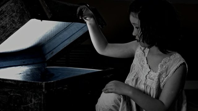 4k Halloween Shot of a Child opening a Vintage chest, black and white
